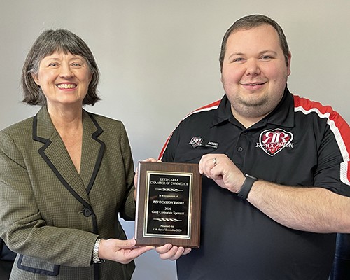 Leeds 2020 Gold Sponsor Revocation Radio presented to Anthony Baumann by Outgoing President Dona Bonnett